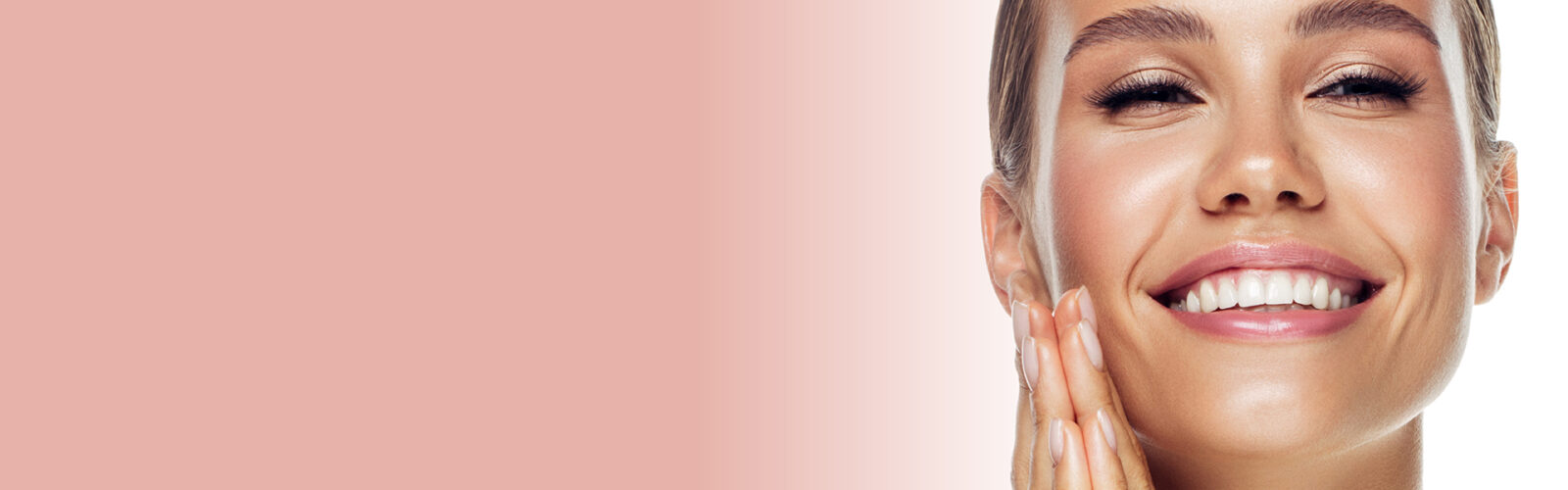 Eine lächelnde, junge Frau mit gefalteten Händen neben dem Gesicht auf rosa-hellblauem Hinergrund. - 